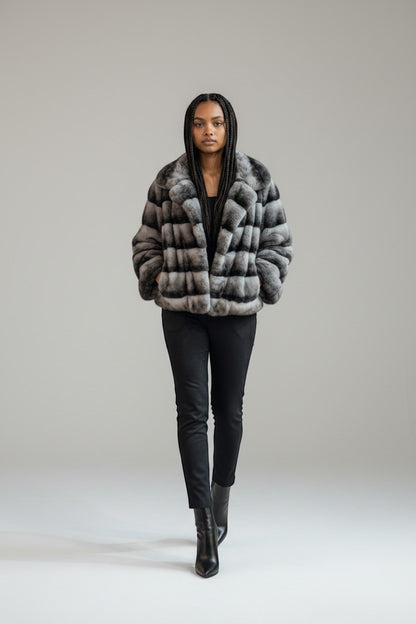 Woman wearing a fur coat walking in a blurred indoor setting