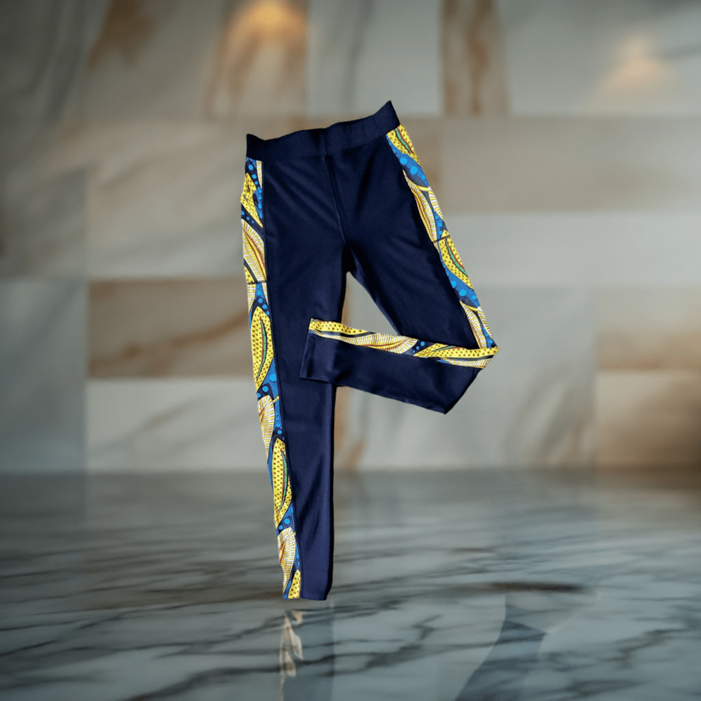 A Leggings with Pockets and Peacock black stand alone with a tan wall background- KRE Prime