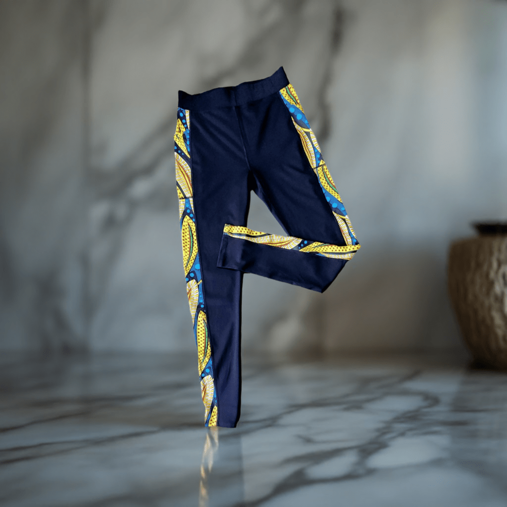 KRE Prime - Black Design Leggings with Pockets standing alone with a tan wall background