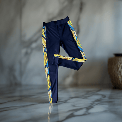 KRE Prime - Black Design Leggings with Pockets standing alone with a tan wall background