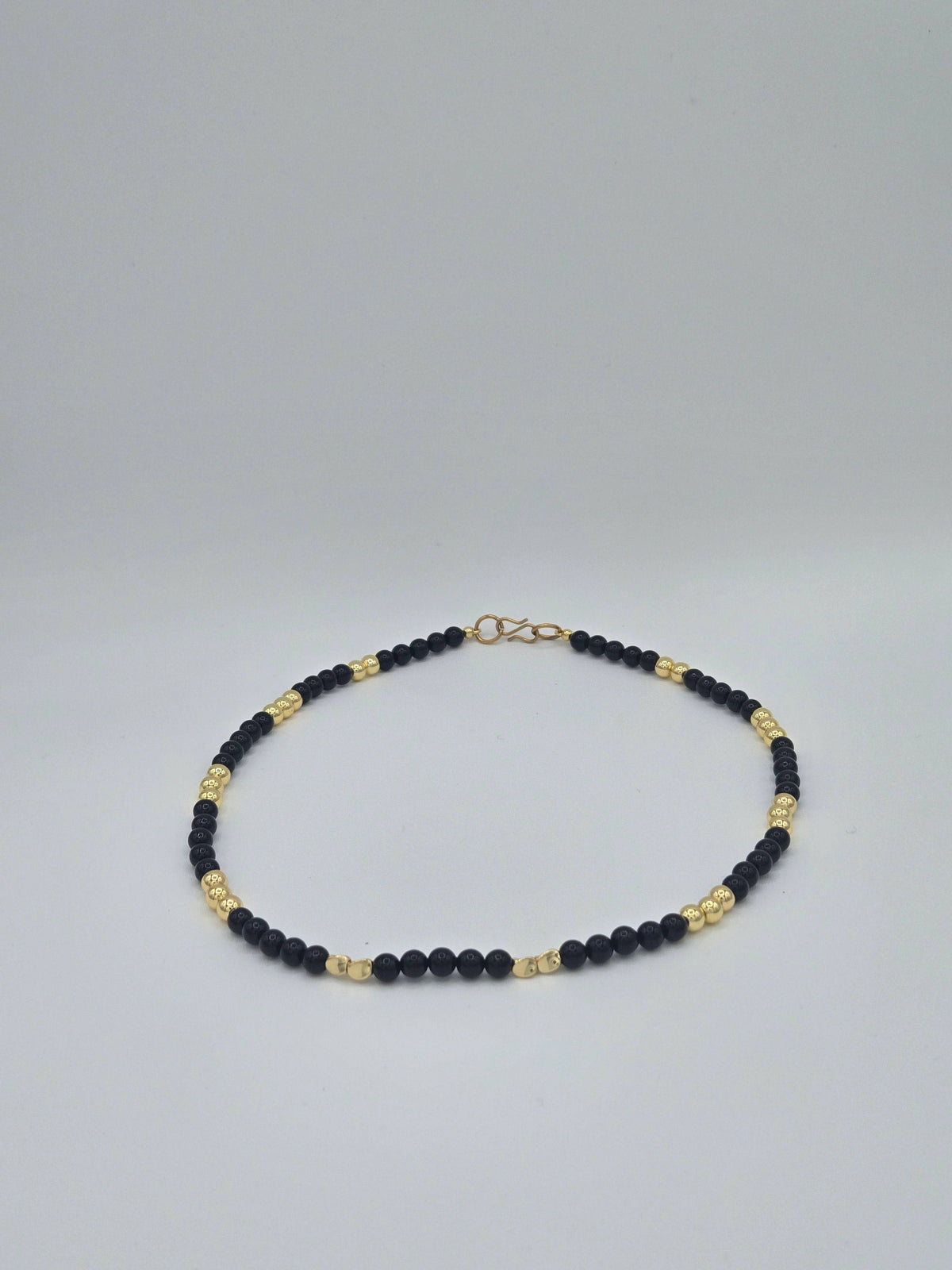 KRE PRIME women’s gold-plated necklace with black beads, elegant opulence design featuring a sleek, stylish jewelry piece.