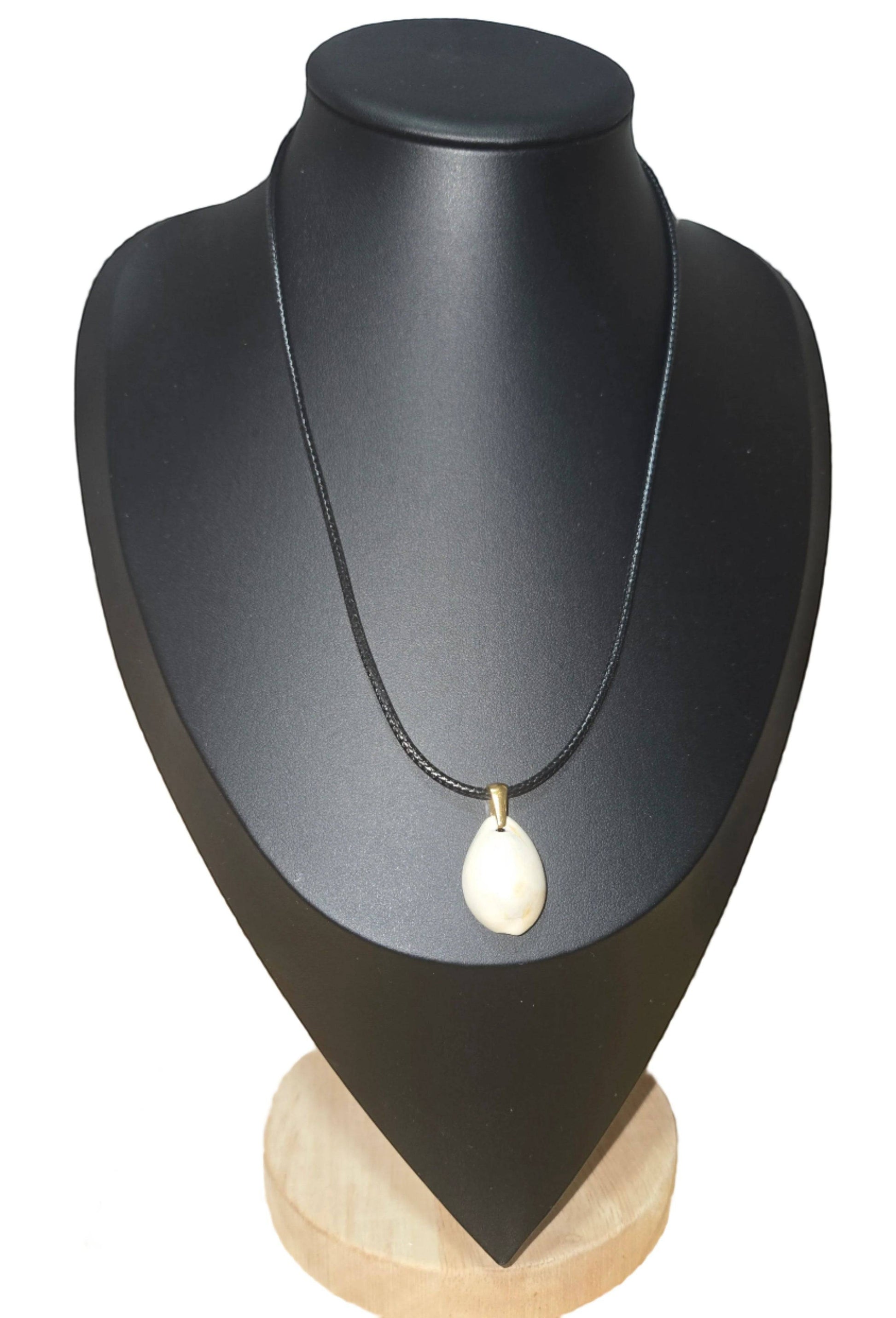 KRE PRIME handcrafted natural shell pendant necklace on a black cord with gold-tone bail.