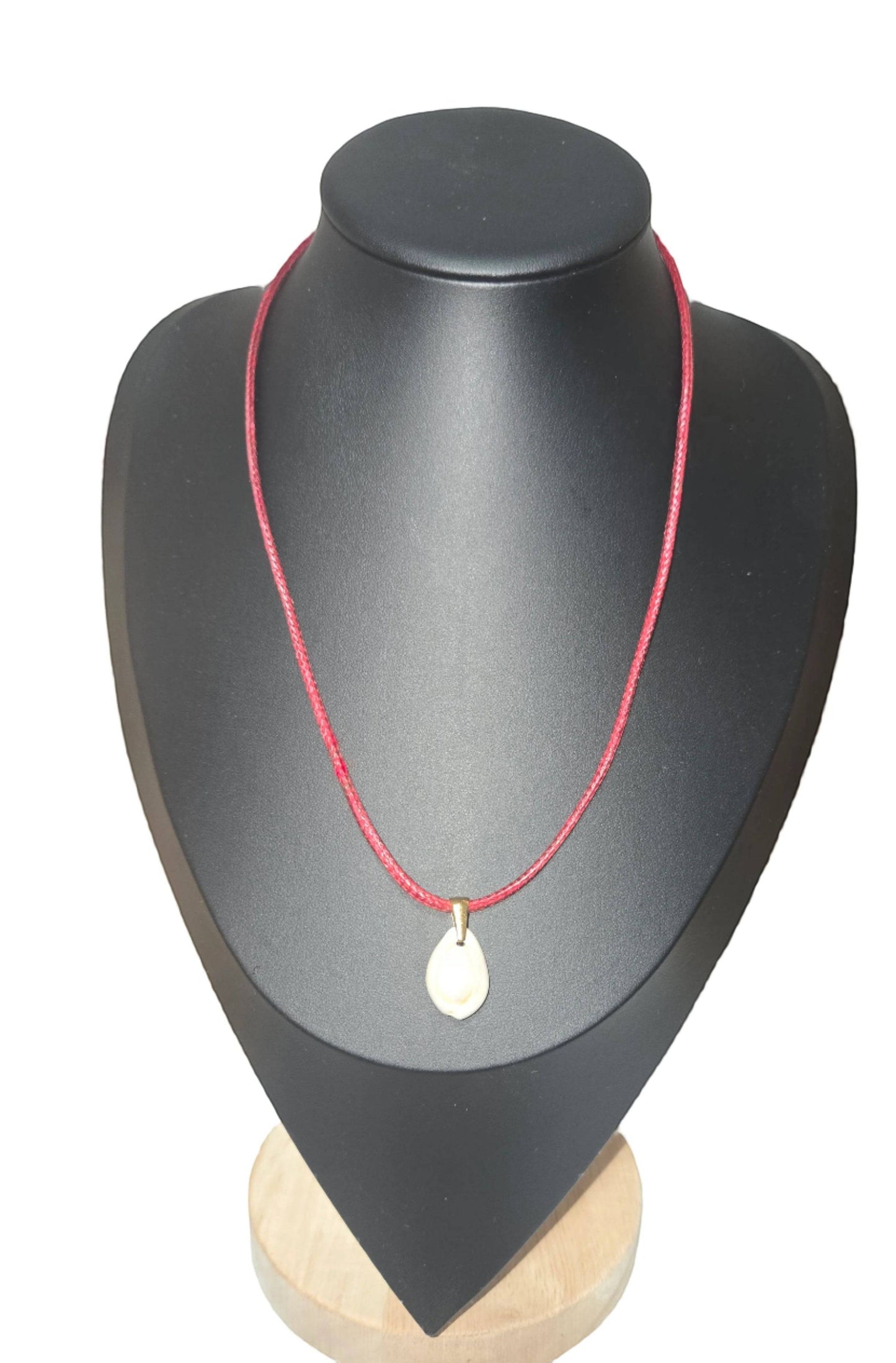KRE PRIME handcrafted teardrop shell pendant necklace on a red cord.