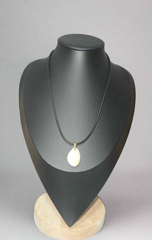 KRE PRIME handcrafted white shell pendant necklace on a black cord with brass accent.