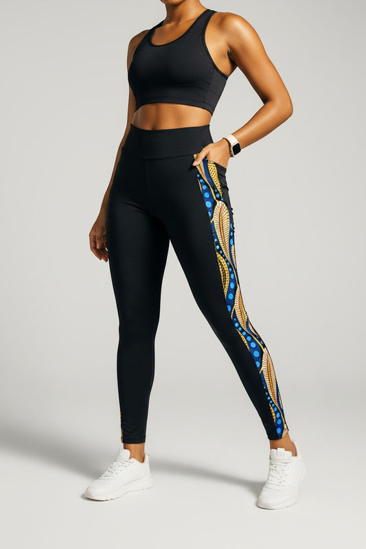 KRE Prime black polyamide-spandex leggings with side pocket and peacock feather print detail.