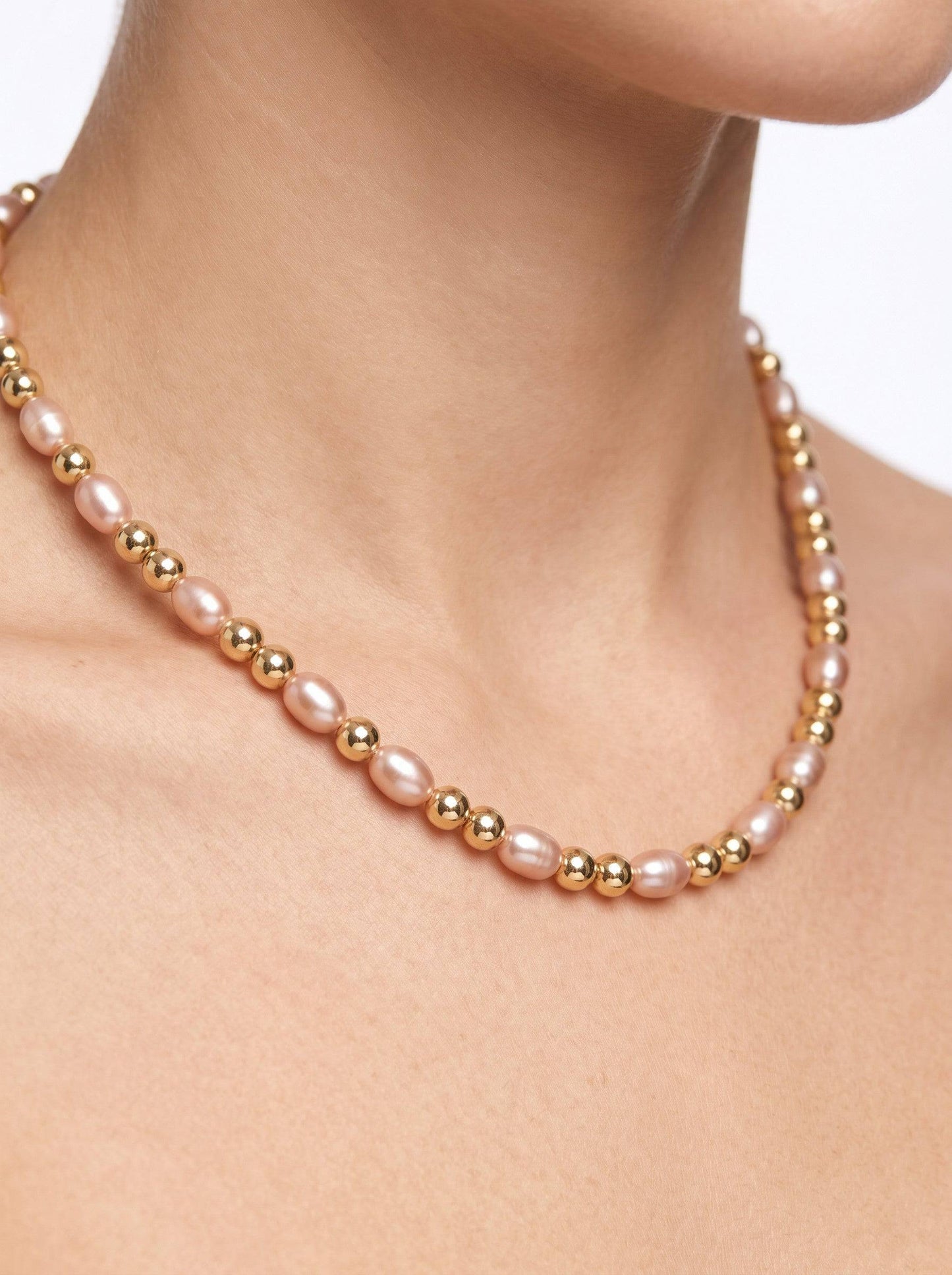 KRE PRIME women's necklace with natural freshwater pearls and 14K gold-filled beads. Features light pink rice-shaped pearls and gold spacers.