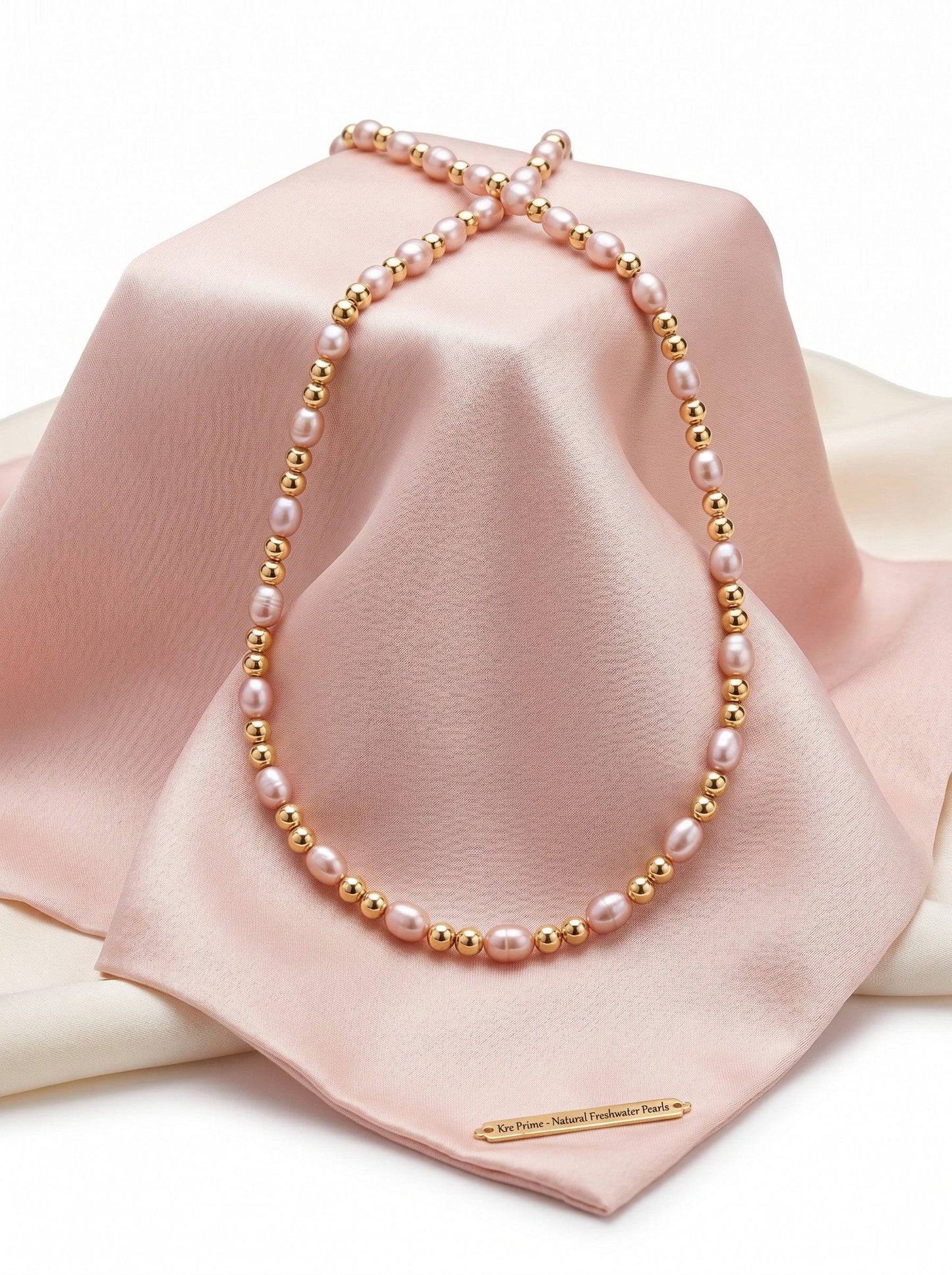 KRE PRIME Women's necklace with natural freshwater pearls and 14K gold beads. Features white/pink pearls and gold accents.