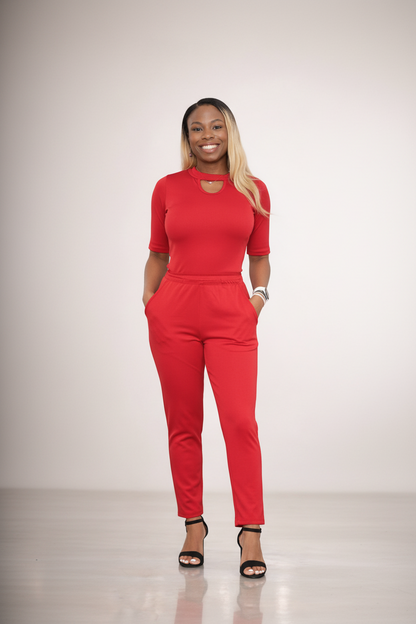 Woman wearing a red outfit on a plain background