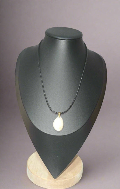 KRE PRIME handcrafted white shell pendant necklace on a black cord with gold-tone bail.
