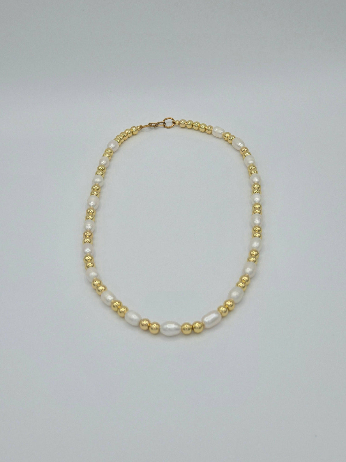 KRE PRIME women's freshwater pearl necklace featuring a string of elegant, natural white pearls on a delicate chain.