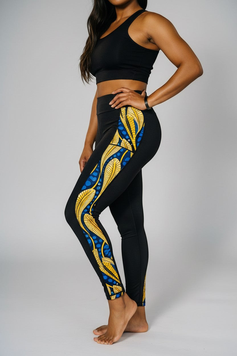 KRE Prime women's black leggings with side panel featuring a blue and yellow peacock feather design. Made from polyamide and spandex.