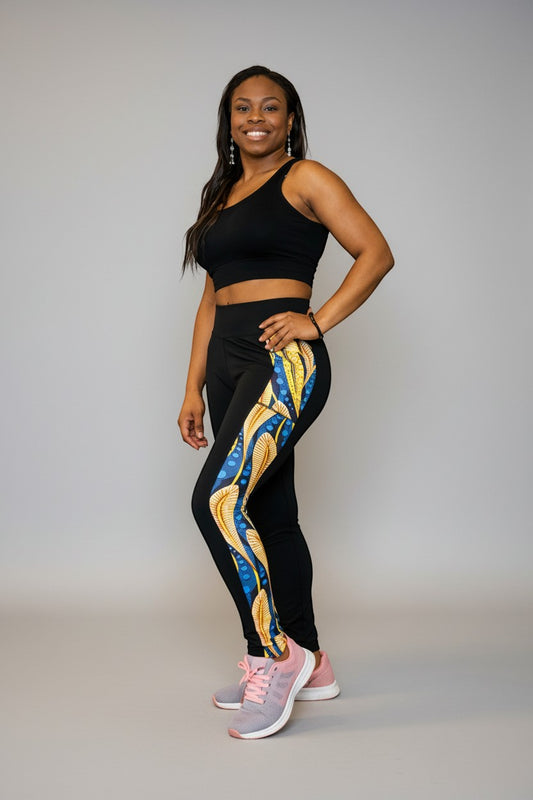 KRE Prime women's black polyamide and spandex leggings with a vibrant blue and gold peacock feather print down the side.