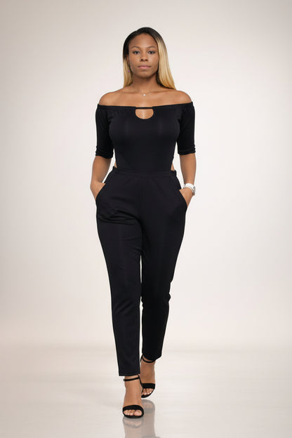 KRE Prime Women's black convertible jumpsuit with off-the-shoulder neckline and side pockets. Made of polyester-spandex blend.