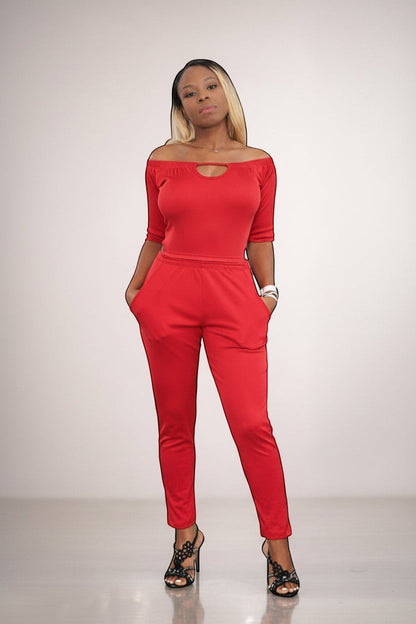 KRE Prime Women’s red convertible jumpsuit with off-the-shoulder neckline and pockets, made of stretch polyester-spandex blend.