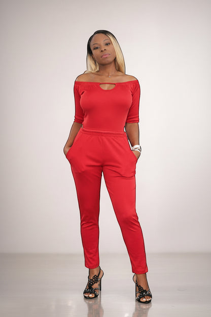 KRE Prime Women’s red convertible jumpsuit with off-the-shoulder neckline and pockets, made of stretch polyester-spandex blend.