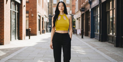 KRE PRIME yellow ribbed crop top with cut-out neckline and halter strap. Made from polyester and elastane.