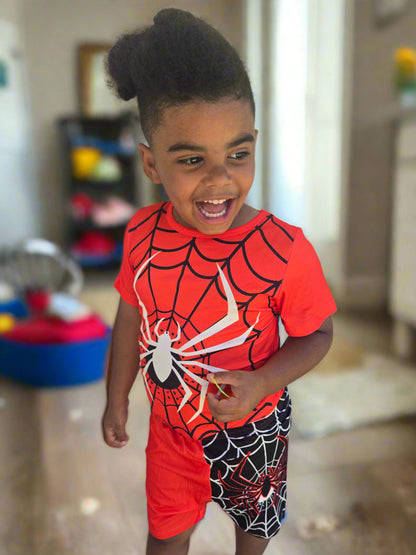 Child wearing a Spider-Man outfit playing
