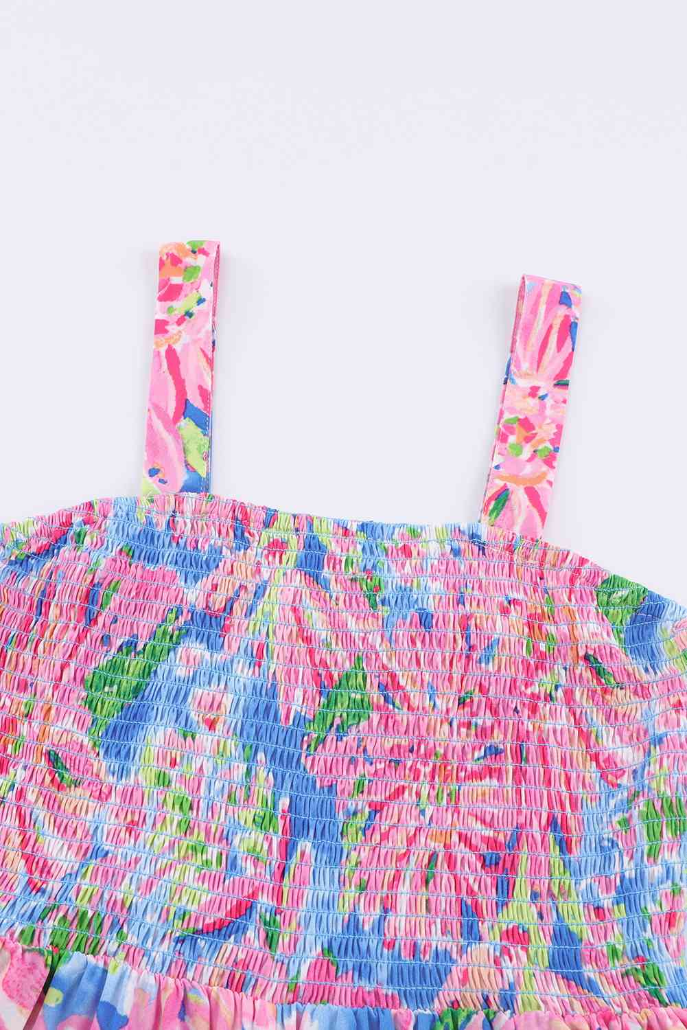 KRE PRIME women's floral smocked square neck jumpsuit with pockets, featuring a fitted waist and lightweight fabric for a stylish look.